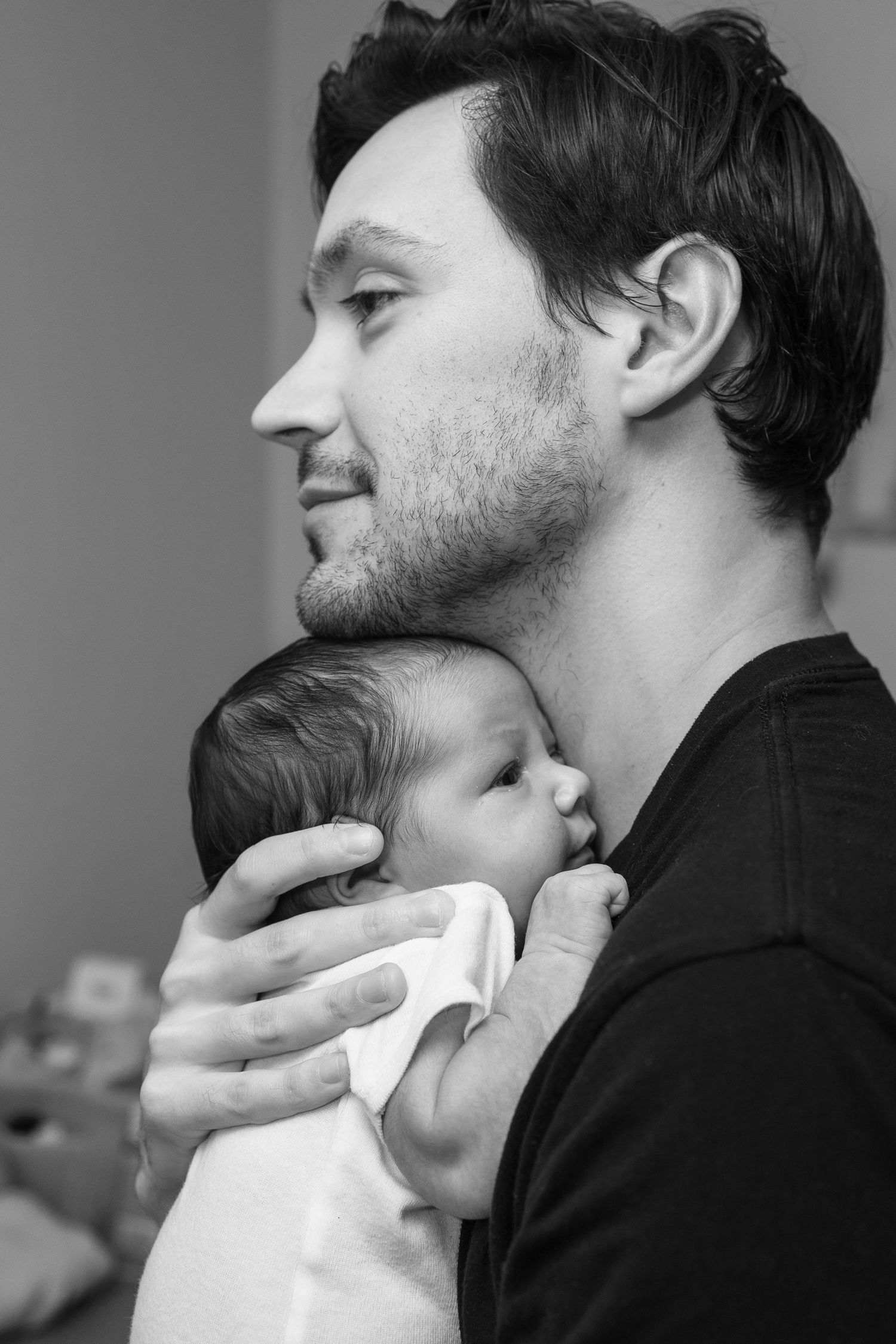 Black and white profile portrait showing tender parent-child interaction.