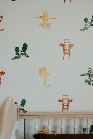 White wall decorated with colorful stamped patterns and designs.