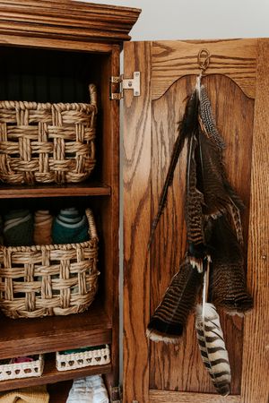 Rustic wooden shelves display woven baskets and decorative items in a farmhouse style.