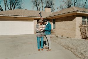 Couple walking together on a winding path during a sunny day.