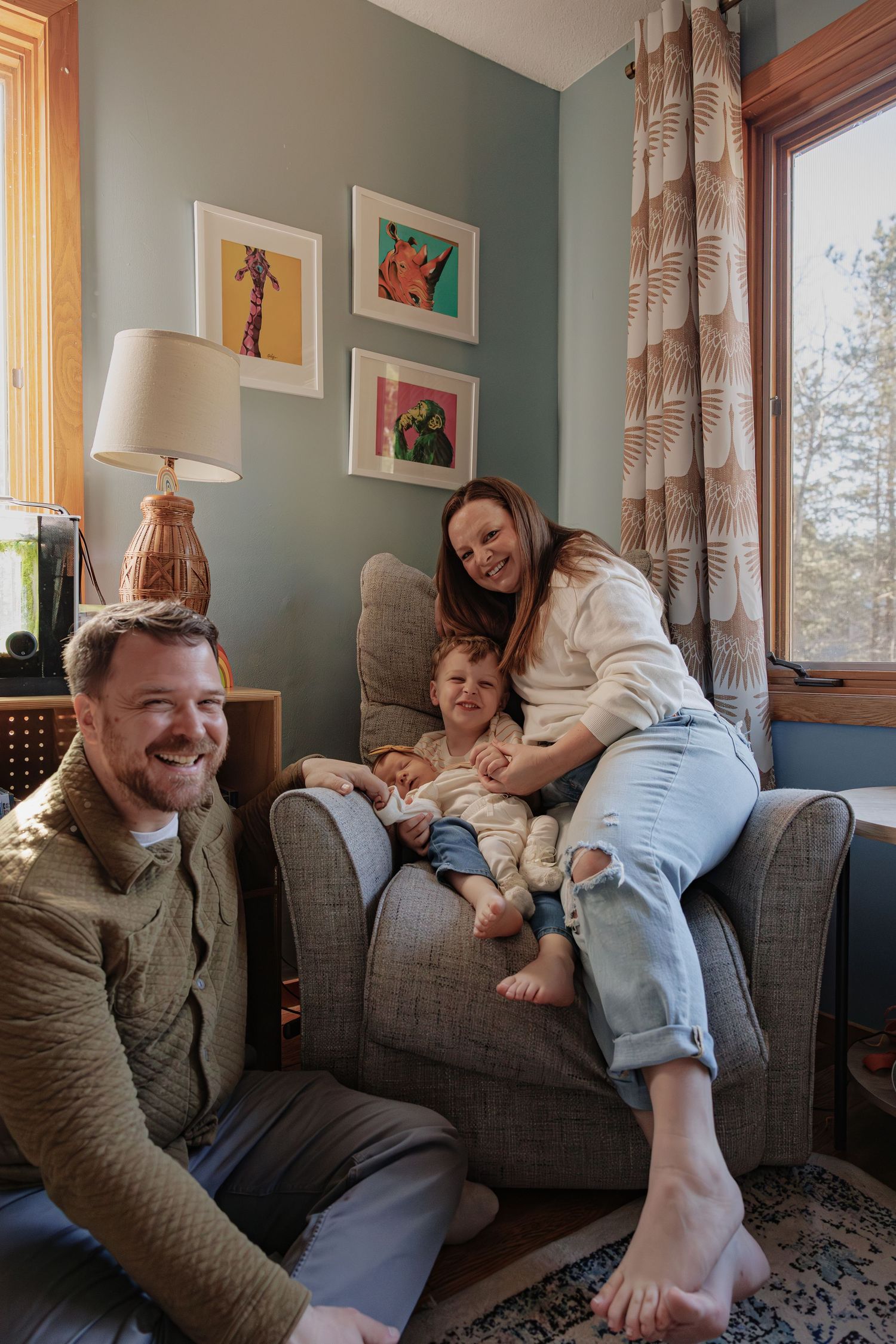 A family gathered on the floor of a living room during a relaxed moment at home.