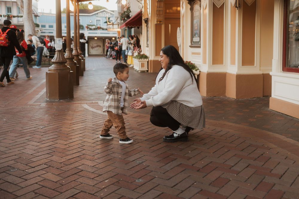 Sweet interaction on brick walkway outside vintage storefronts.