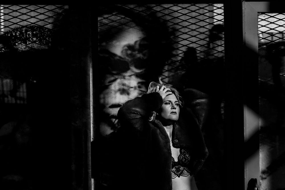A black and white film noir collage of dark moody scenes depicting dramatic lighting and shadows in an atmospheric setting.