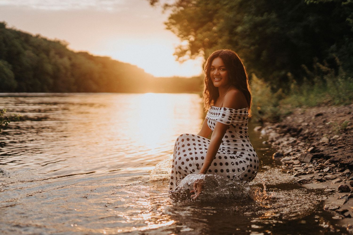 Black and white portrait along waterfront path with natural lighting.