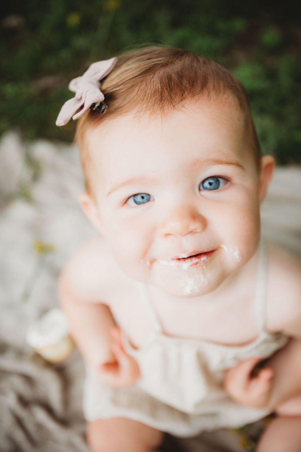 Close-up images of a baby with bright blue eyes making various adorable expressions in a warm, natural light setting.