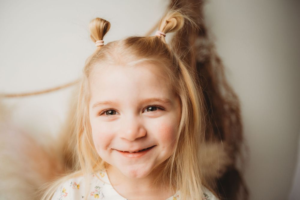 A series of five similar photos showing a child with blonde hair and natural expressions against a light background.
