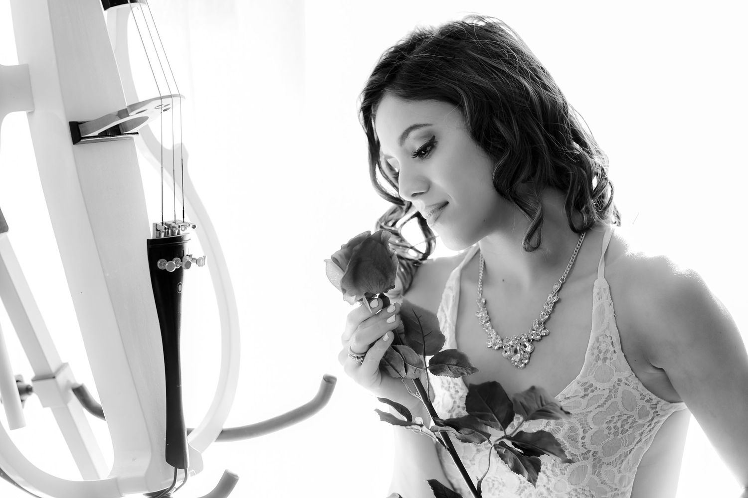 Black and white romantic portrait with roses and delicate lace details.