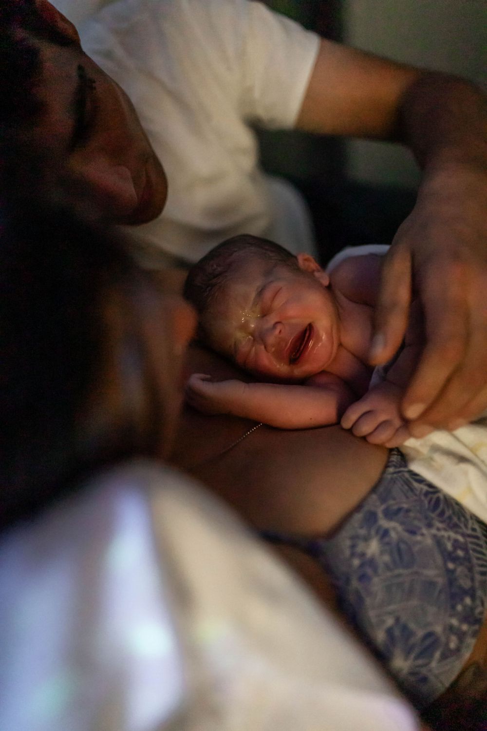 Raw emotional photograph of a newborn moments after birth.
