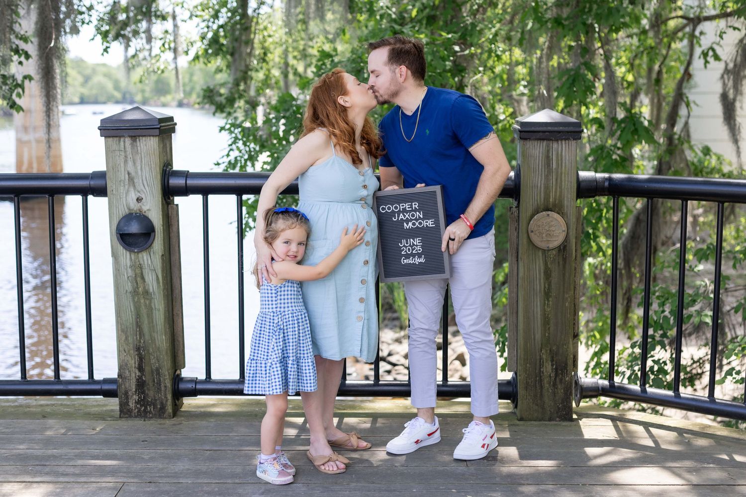 Outdoor maternity session under trees in a park with her family, captured by Tasha Cannaday a Essex County photographer