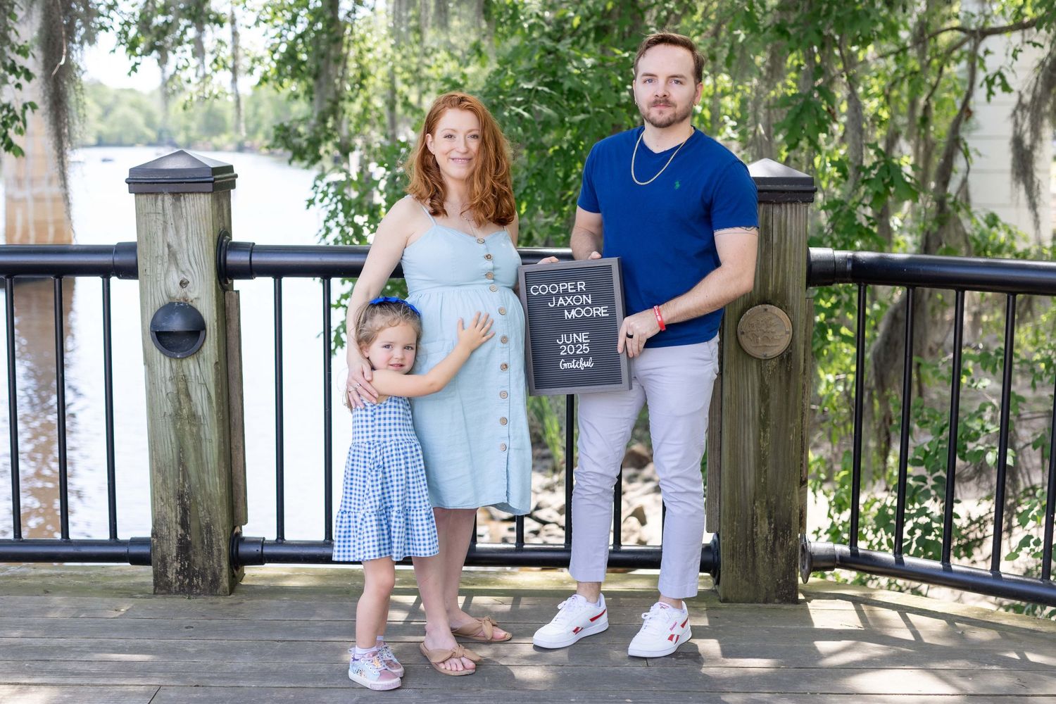 Beautiful outdoor maternity session under trees in a park with her family, captured by Tasha Cannaday a Essex County photographer