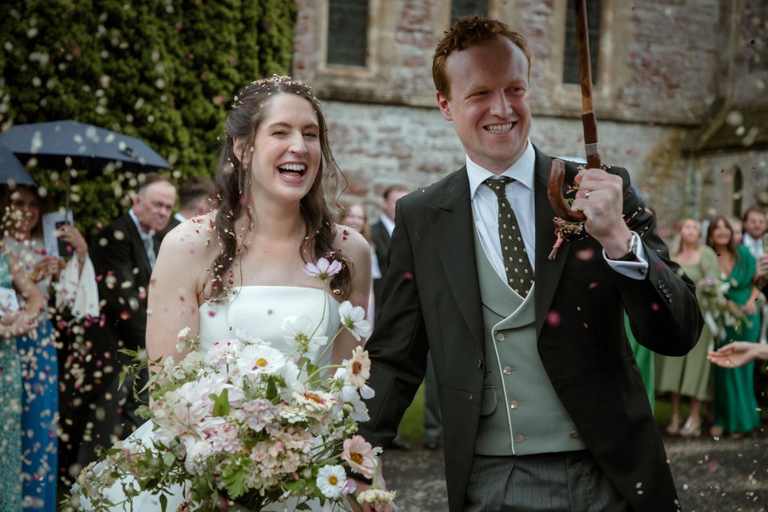 confetti bride and groom umbrella candid fun Photography