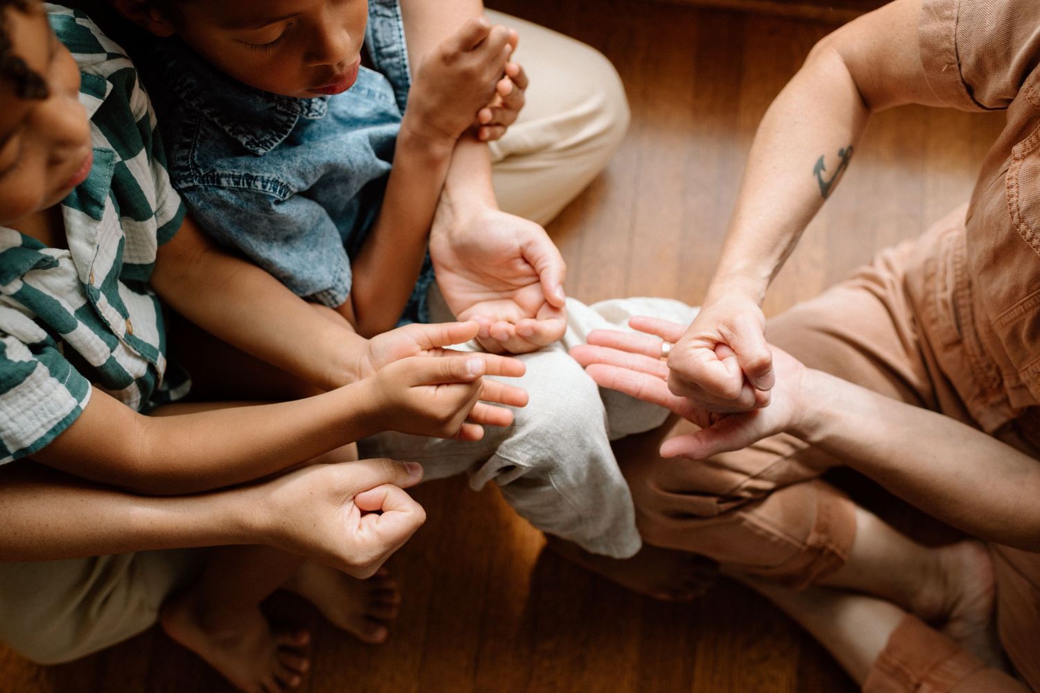 Close up view of hands resting on laps while attending a religious service or meditation gathering.