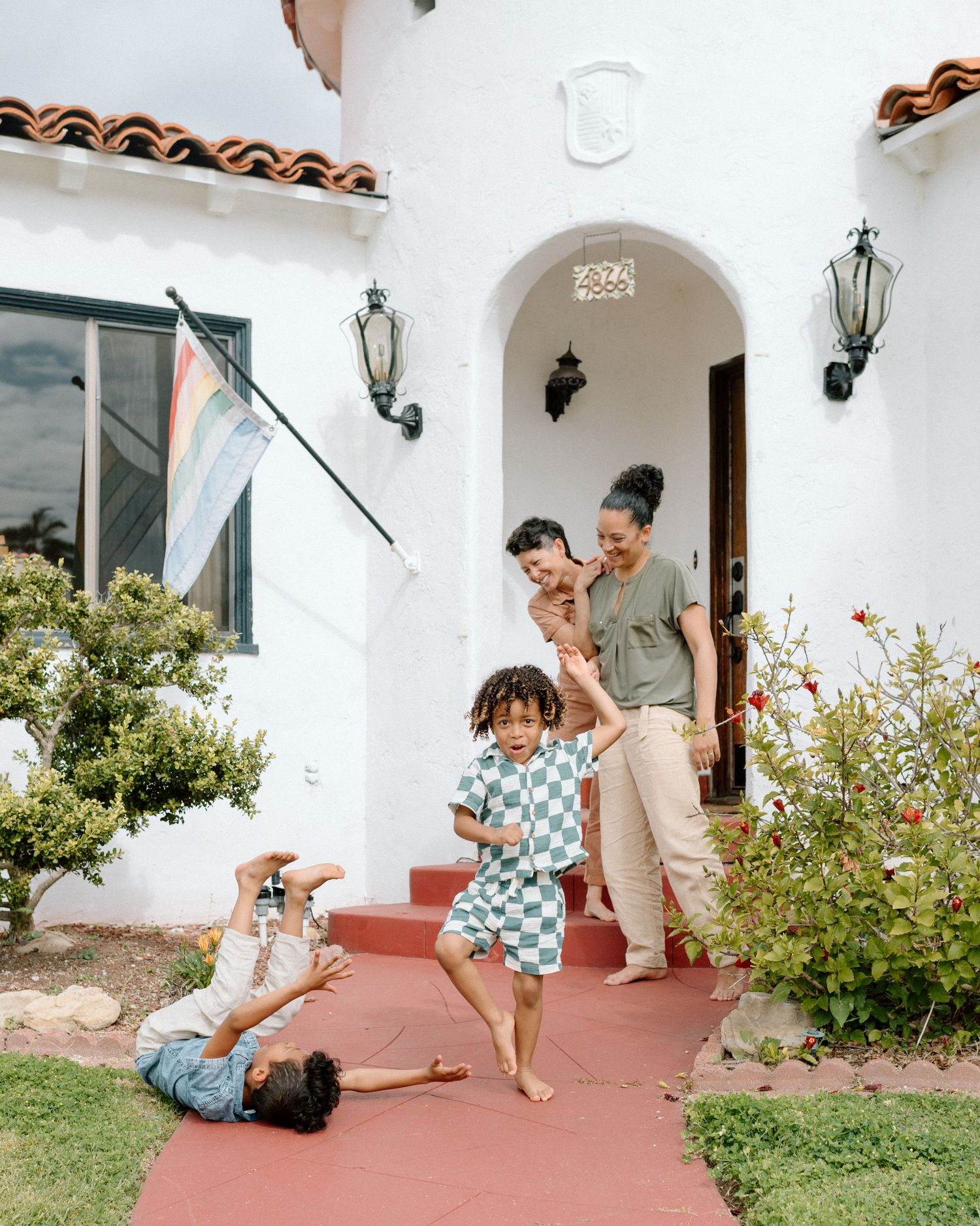 A playful sequence of photos shows a joyful dance moment between two people on a white Mediterranean-style patio.