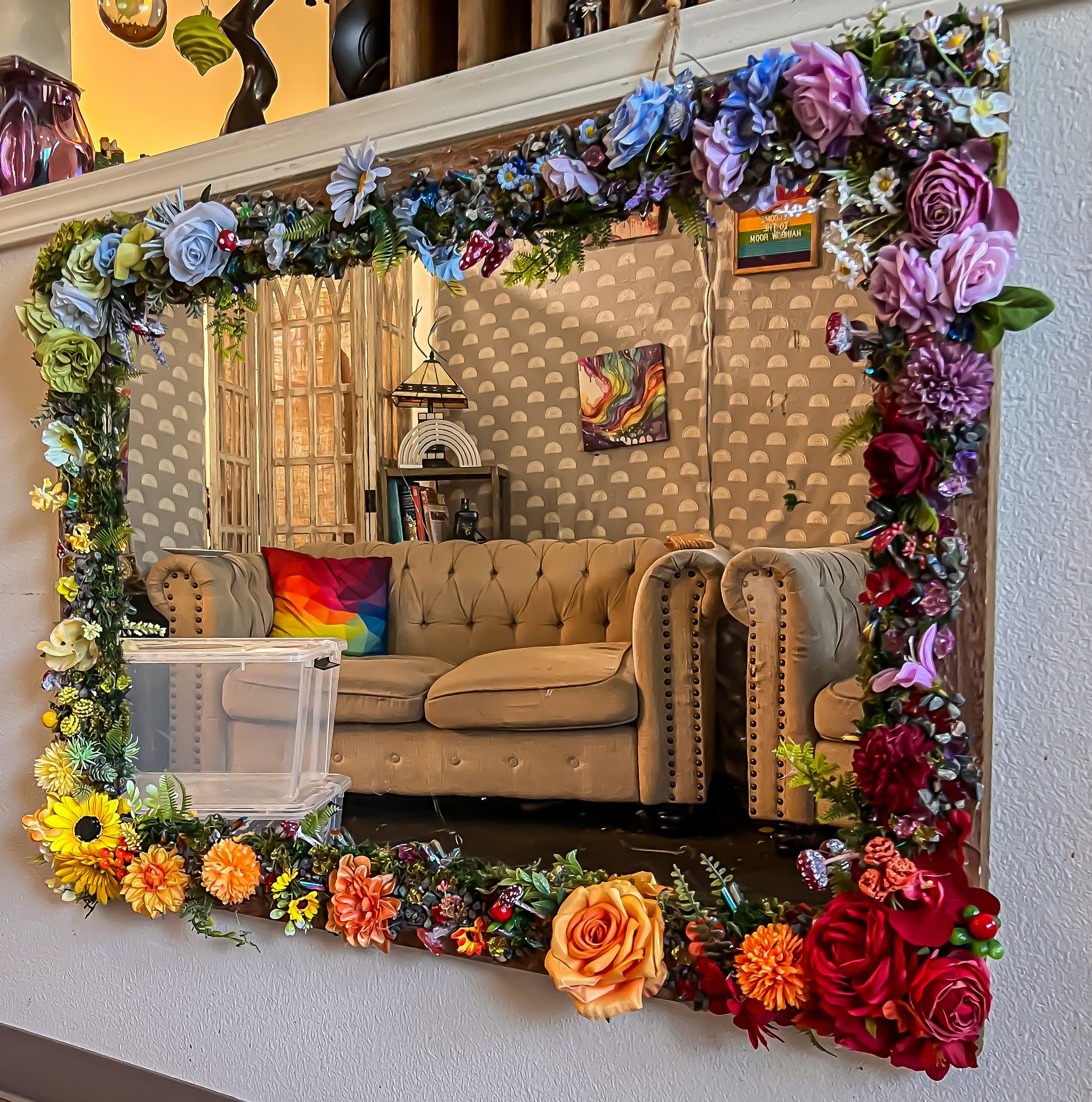 Decorative mirror with colorful floral frame featuring roses, sunflowers, and mixed blooms.