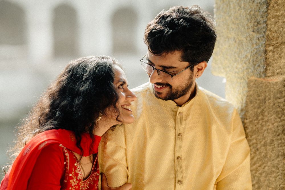 A romantic moment captured between two people wearing traditional Indian outfits.