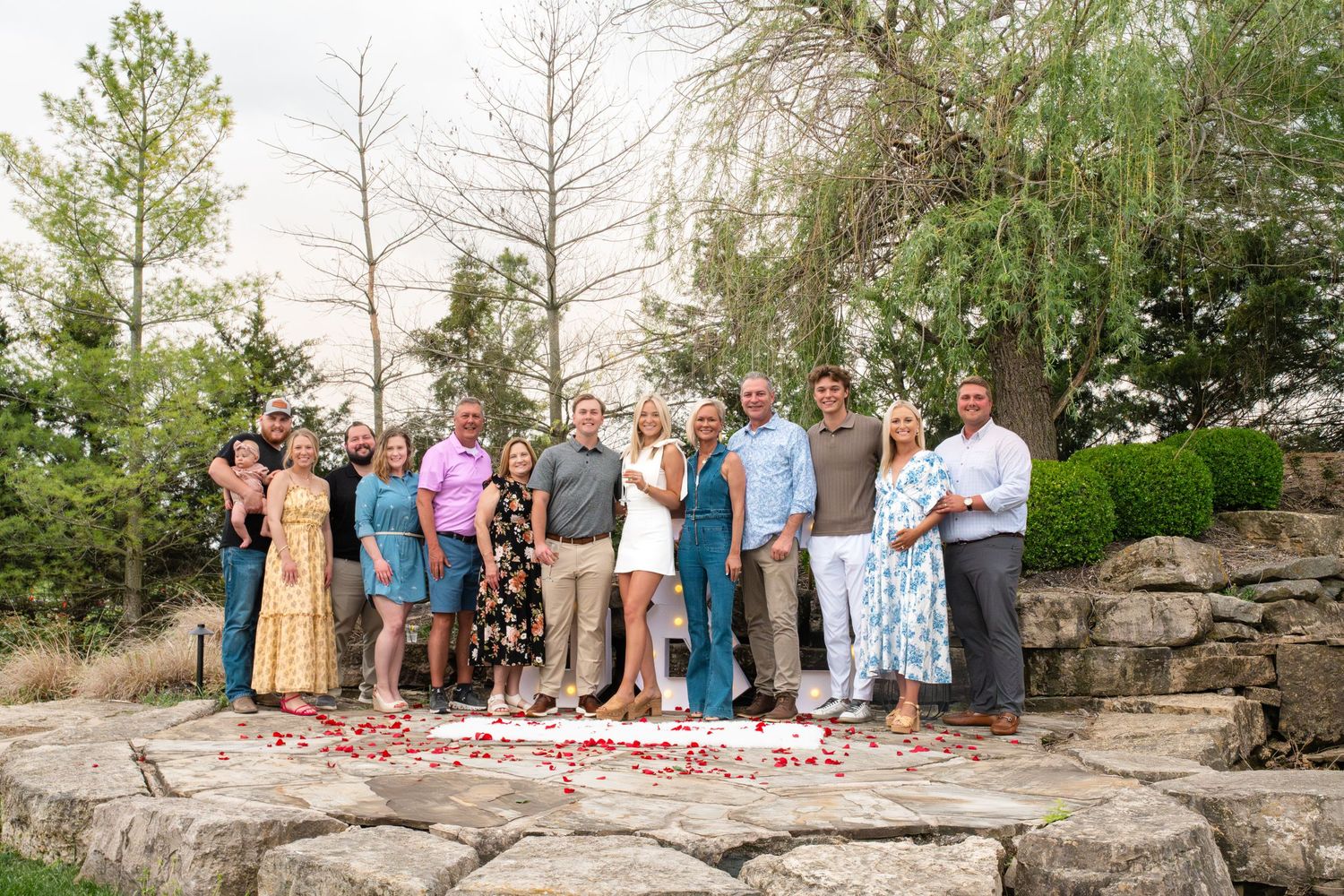 Large group photo of people lined up on stone steps outdoors.
