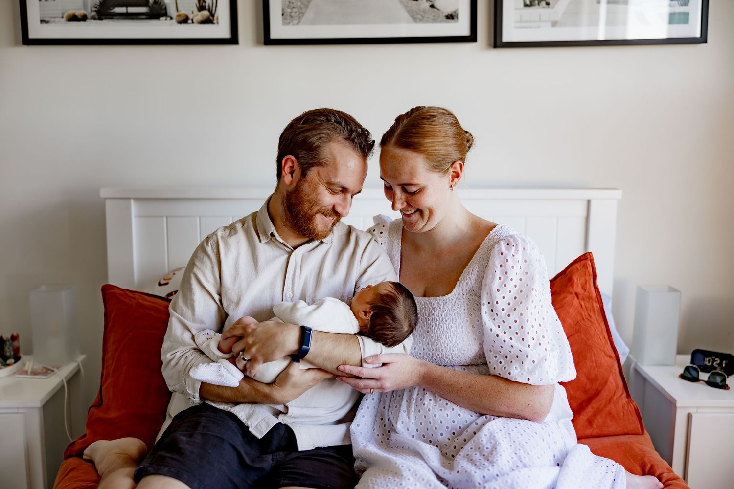 A collection of five monochrome photographs showing tender domestic moments arranged in a gallery wall style display.
