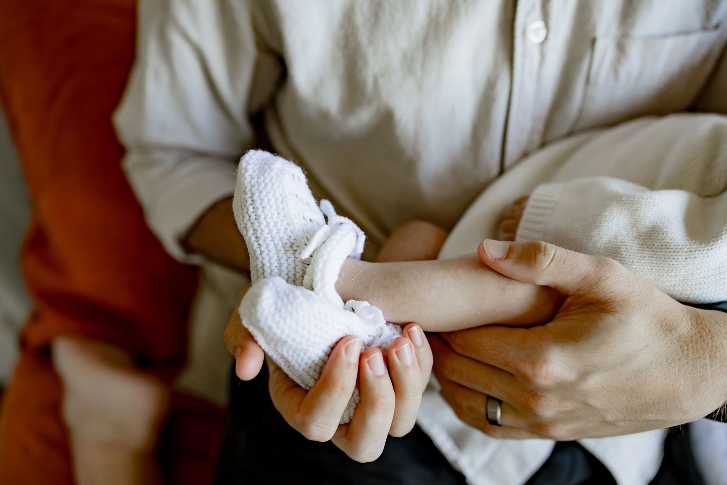 A close-up sequence showing hands wrapping white bandage material around a person's arm or finger.