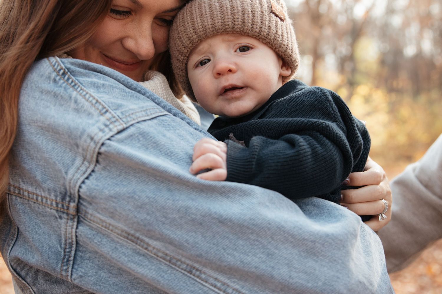 Cozy autumn family portrait with warm knit sweaters and gentle embraces.