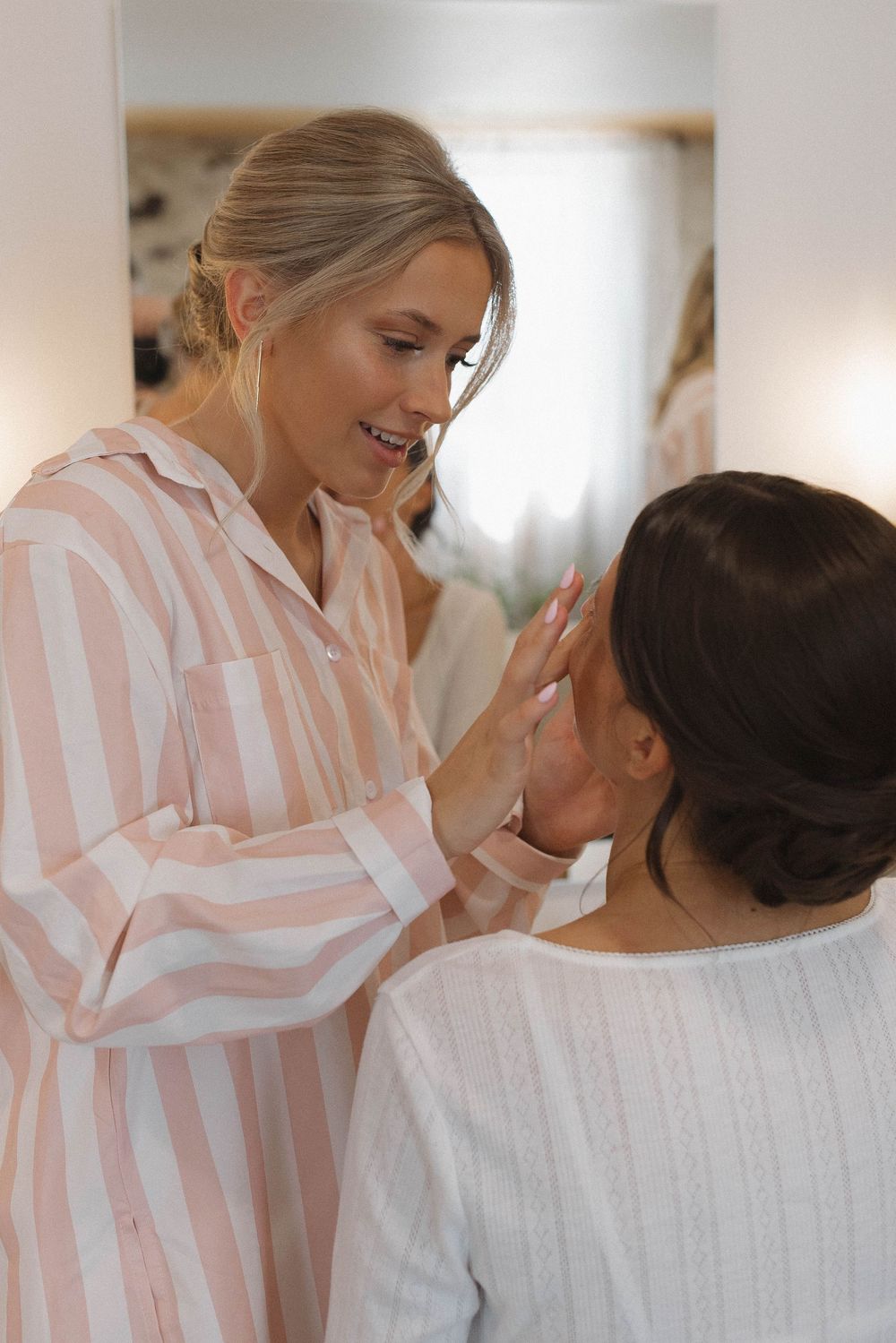 Emotional pre-wedding preparation moment in soft natural light.
