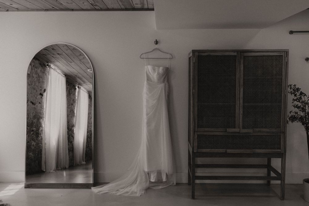 Minimalist wedding venue interior with wooden benches and white walls.