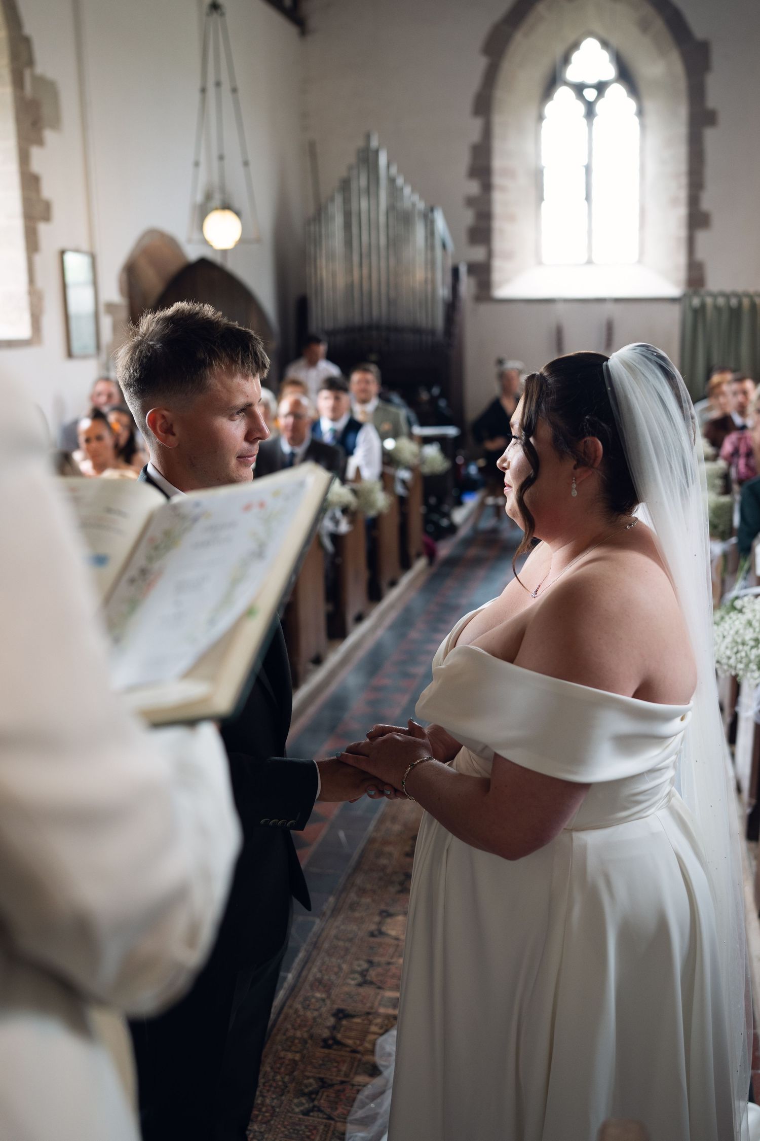 Seven sequential wedding photographs show tender moments during a church ceremony in a beautiful gothic interior.