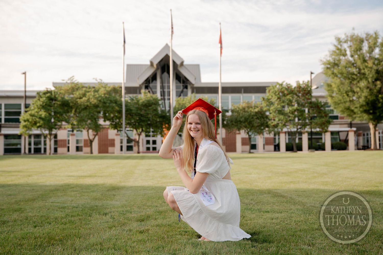 A series of five photos shows a solo figure in a white flowy dress dancing and twirling outdoors against a school building backdrop.