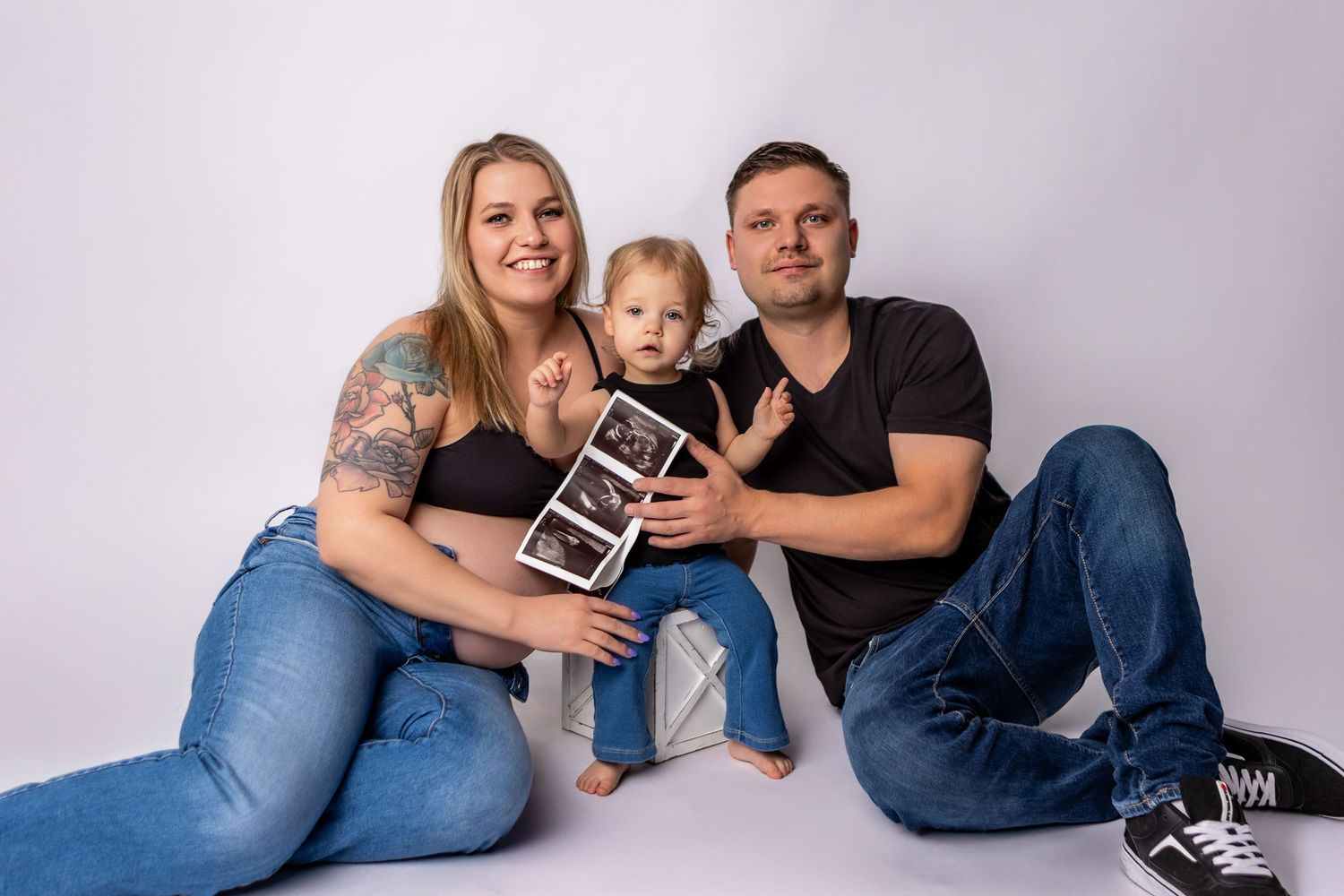 A series of pregnancy announcement photos showing a couple and small child holding ultrasound images on a light background.