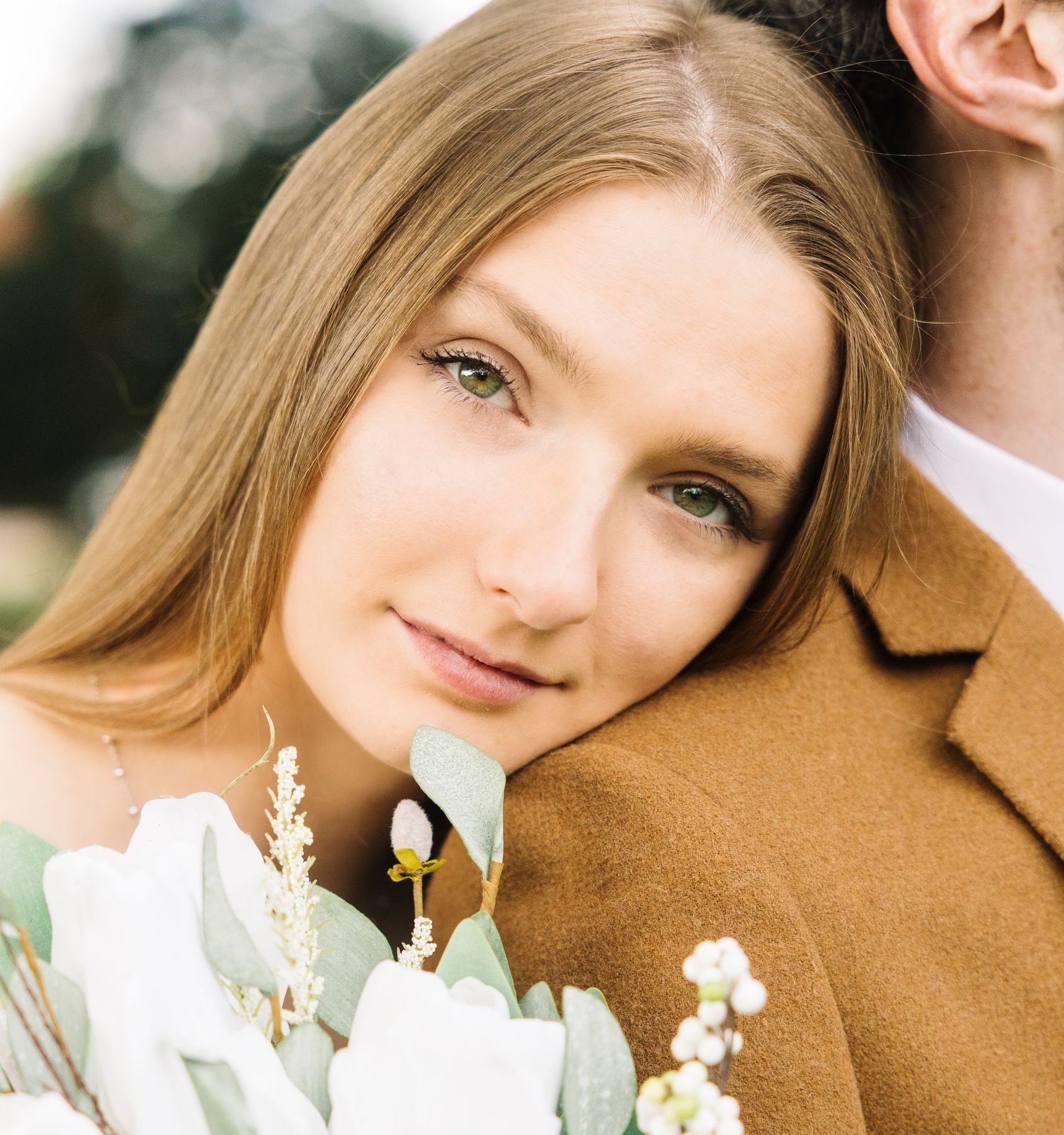 A happy couple shares romantic moments together in black and white wedding photos set in a park.