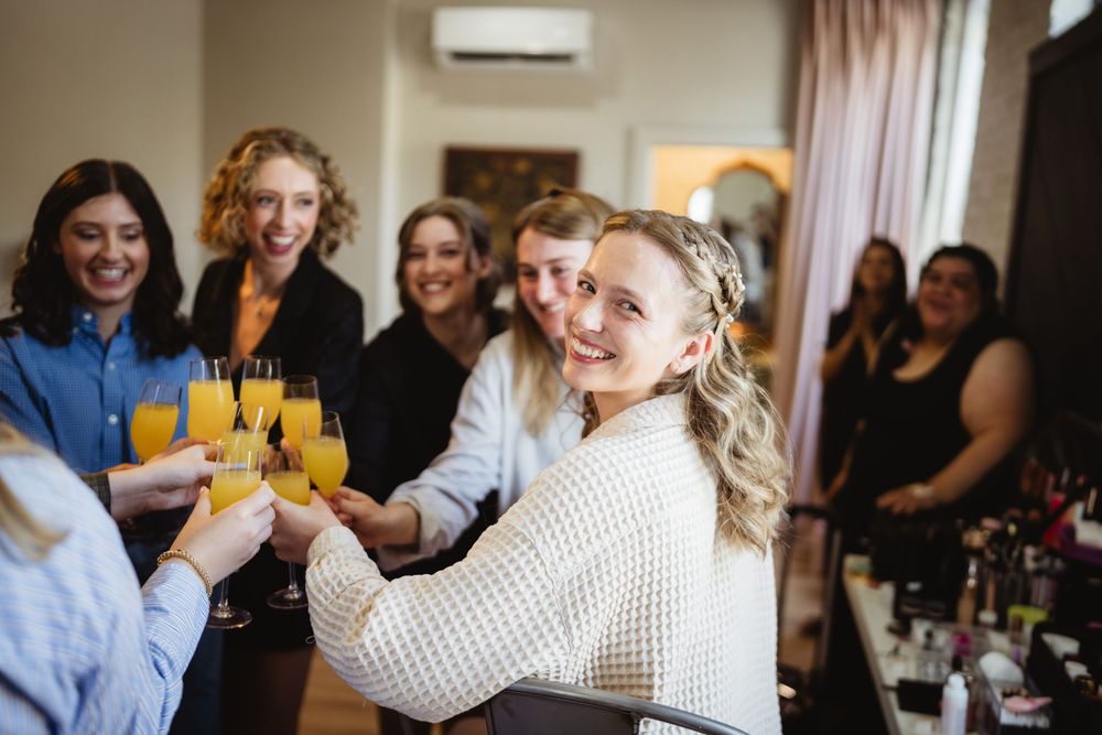 Cheerful group enjoys drinks and conversation at a social gathering with friends seated around a table.