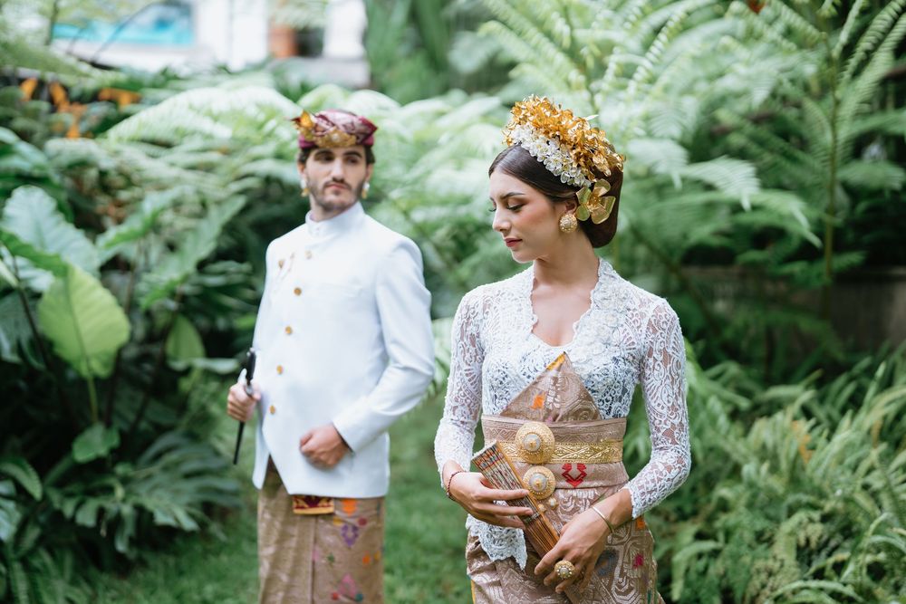 Traditional Balinese wedding photoshoot in a verdant tropical garden setting.