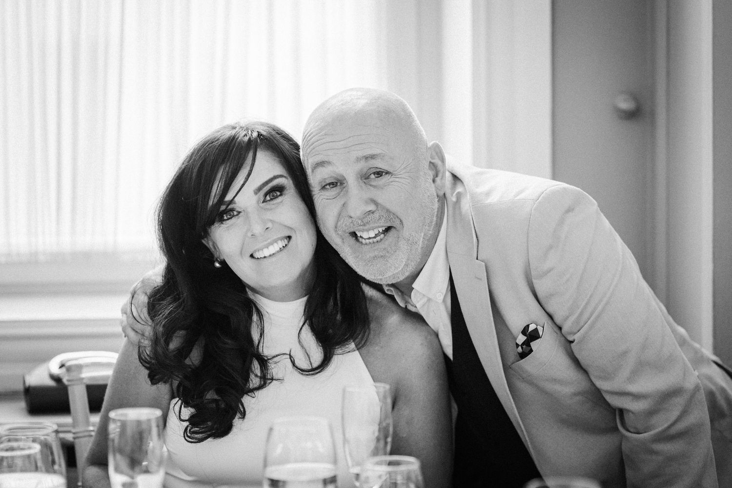 Black and white photo series of a couple posing closely together in an intimate setting.