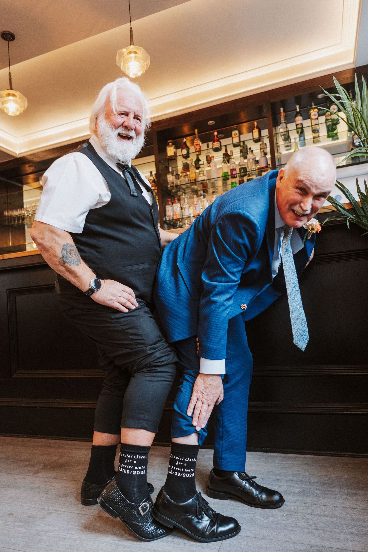 A sequence of cropped photos showing black dress shoes with dress socks at a bar.