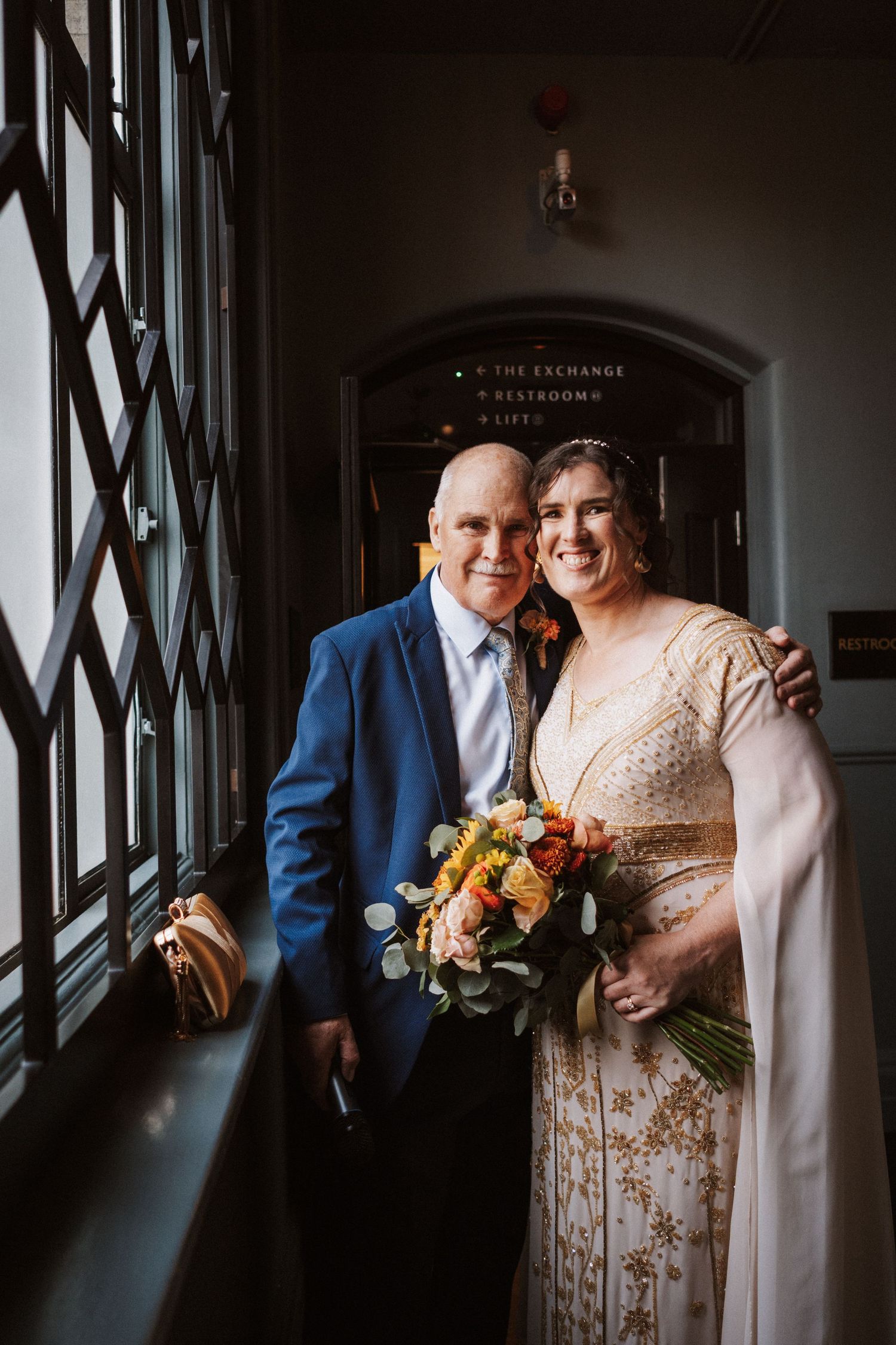 Four moody and intimate wedding photos showing a couple sharing candid moments in front of french doors.