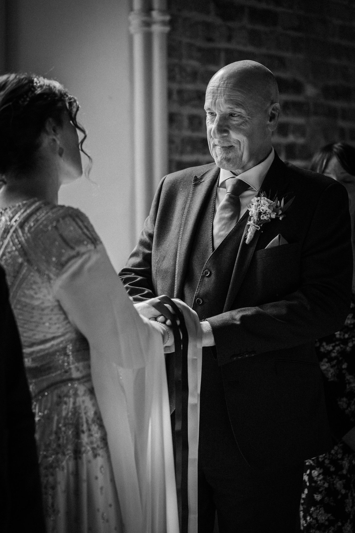 Black and white candid wedding photos showing intimate moments of a couple in formal attire dancing indoors.