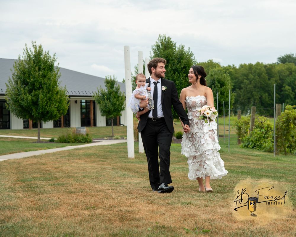 A scenic outdoor wedding photoshoot with a modern building in the background.