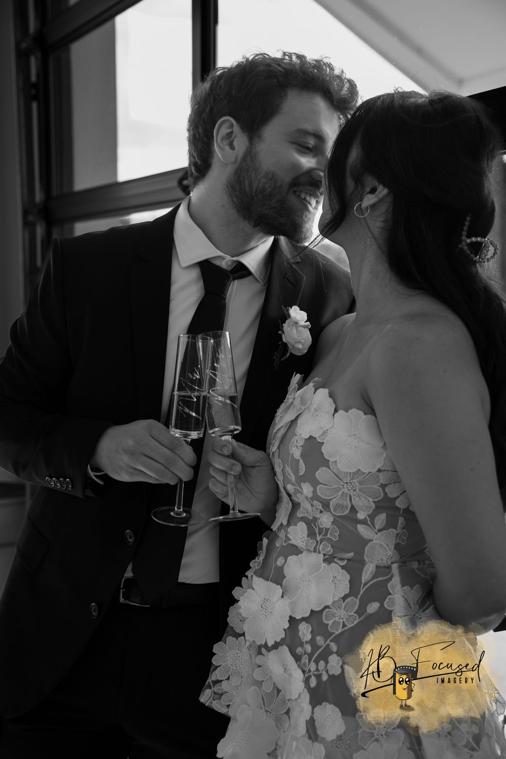 Intimate black and white wedding moment with floral dress details.