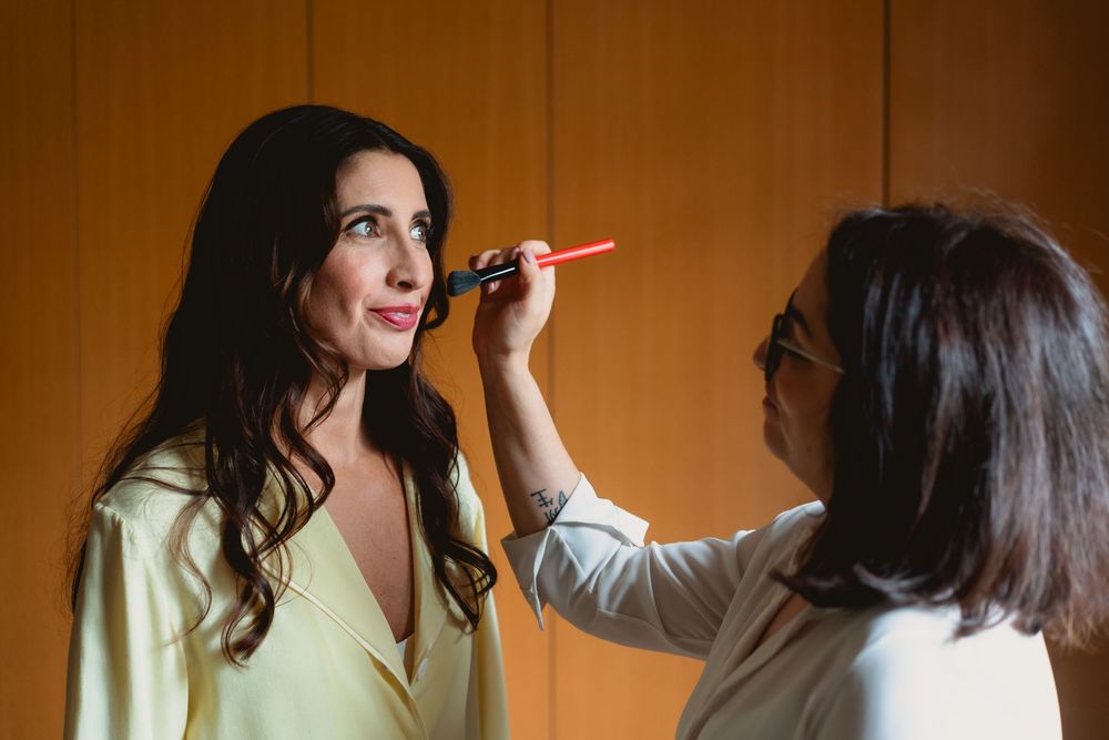 A series of candid shots showing someone applying makeup in warm lighting.