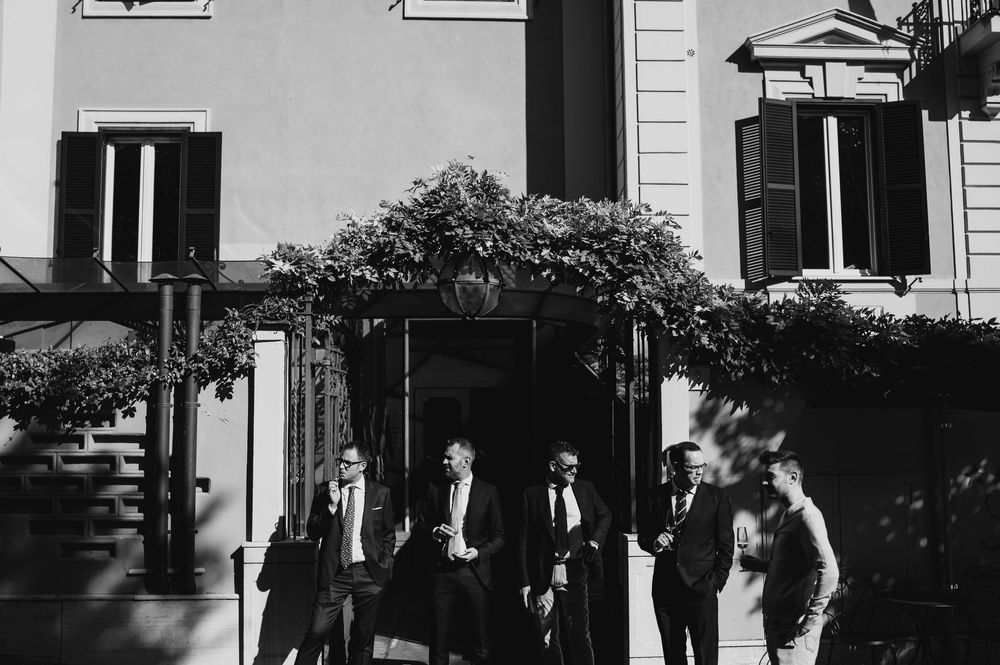 Black and white photo sequence showing people walking and interacting outdoors.