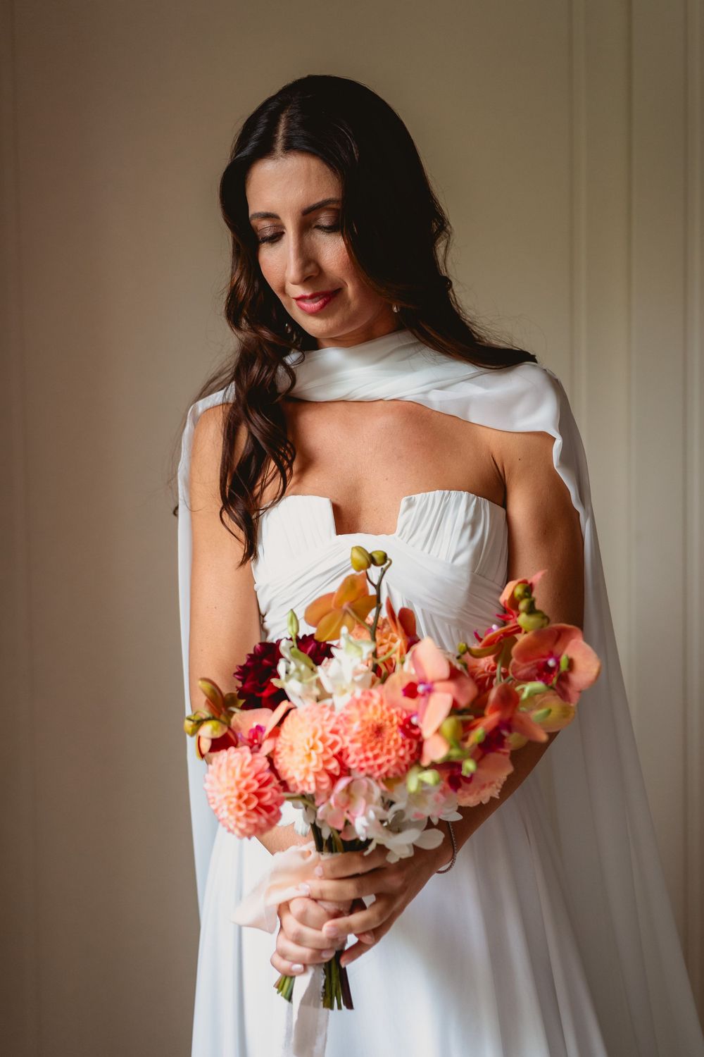 Close-up shots of a vibrant bridal bouquet with coral dahlias and mixed flowers.