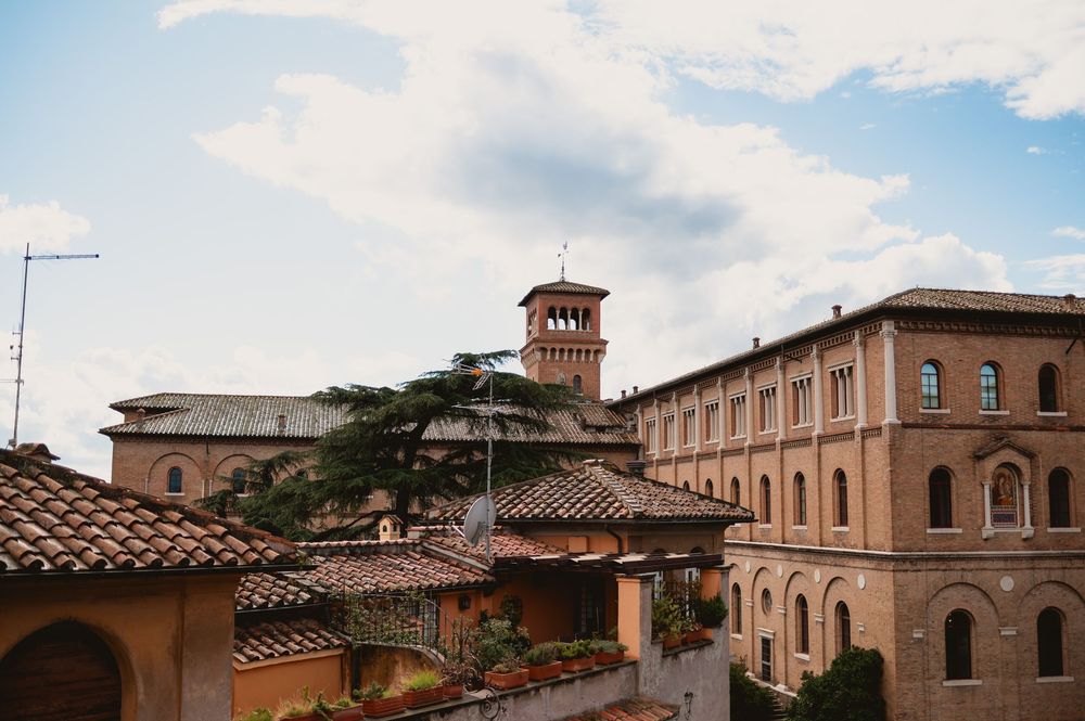 Panoramic view of Italian architecture with terracotta roofs under blue sky.