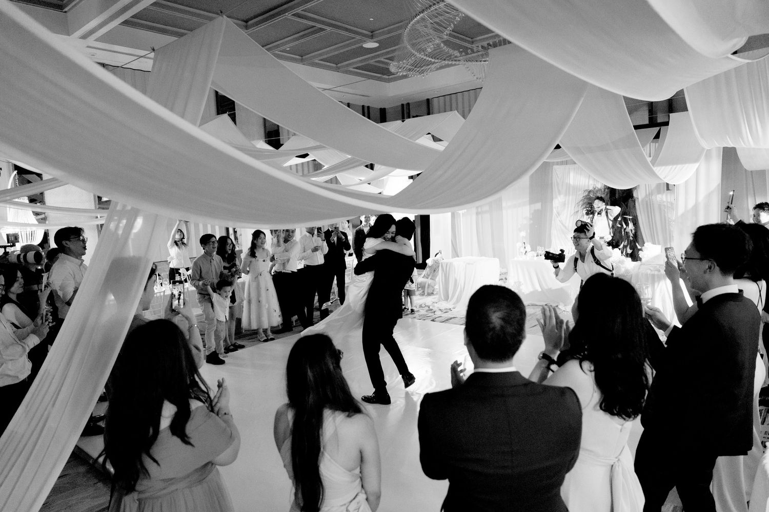 Black and white aerial view of wedding reception first dance with guests surrounding the dance floor.