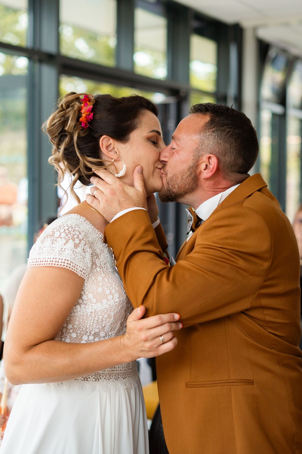 Tender moment shared between newlyweds during wedding ceremony.