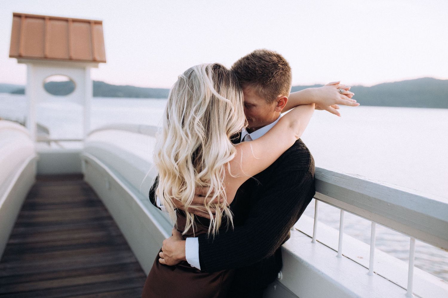 Engaged couple during a romantic engagement session on Coeur d’Alene Lake in North Idaho