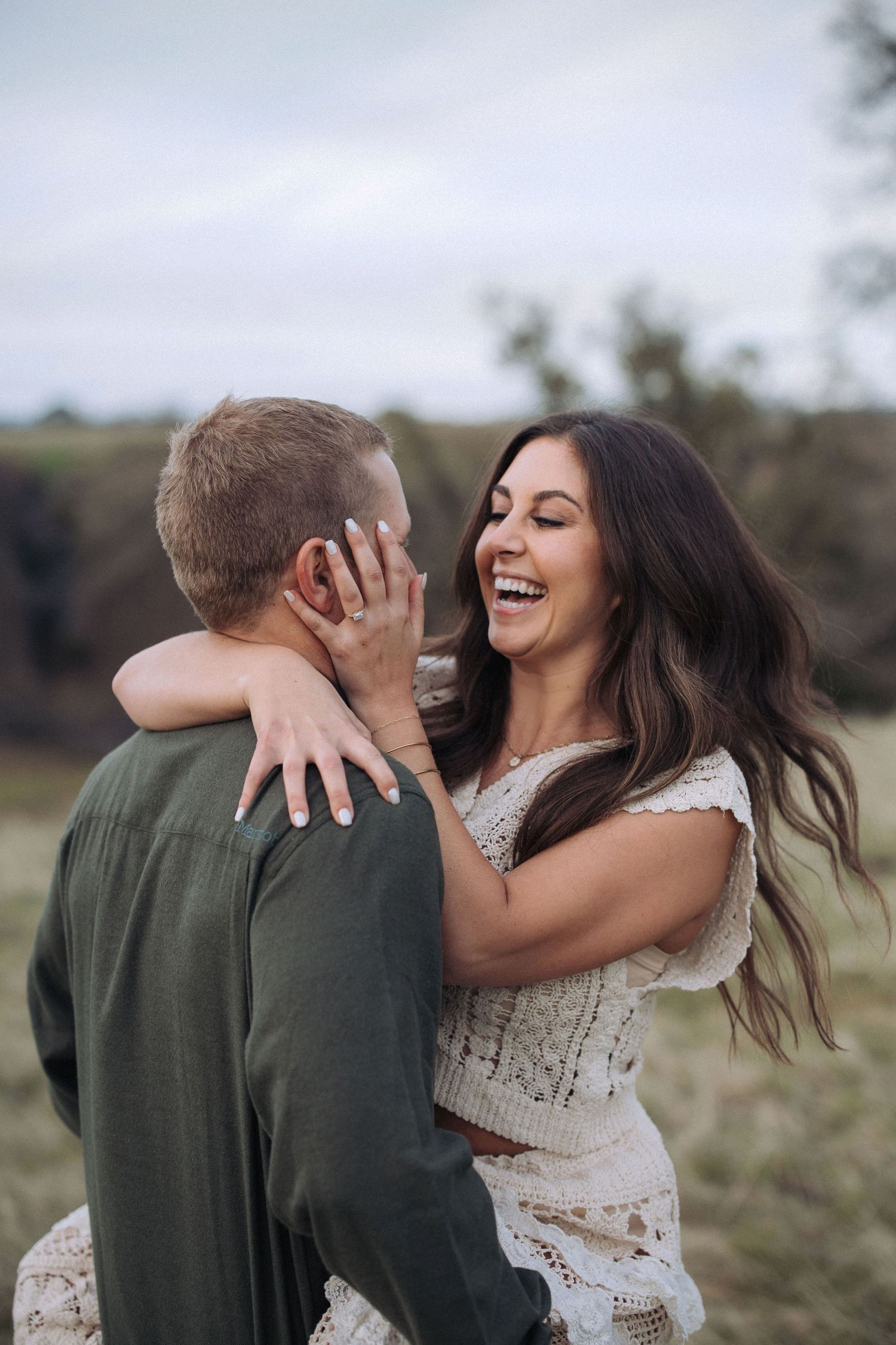 Couple embracing during an outdoor engagement session in North Idaho