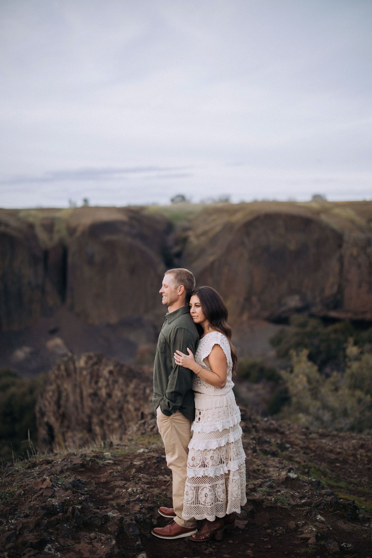 Couple embracing during an outdoor engagement session in California