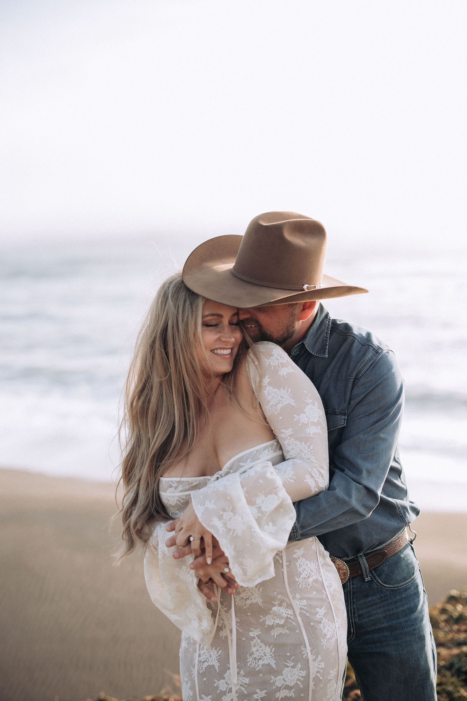 Couple embracing during an outdoor engagement session in North Idaho