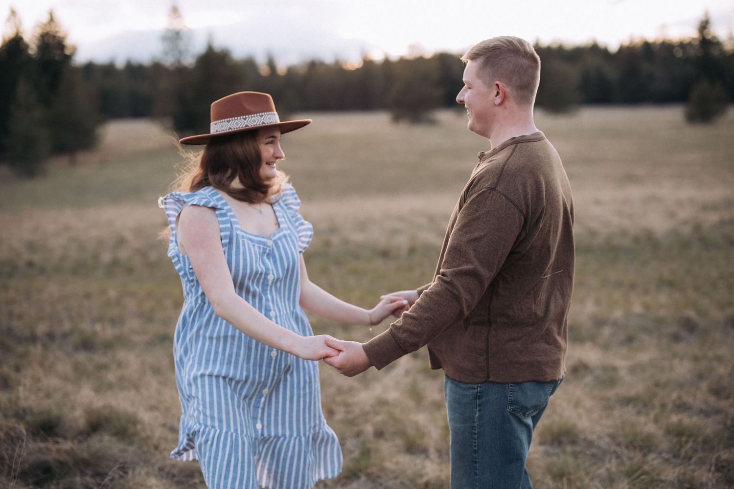 Couple embracing during an outdoor engagement session in North Idaho