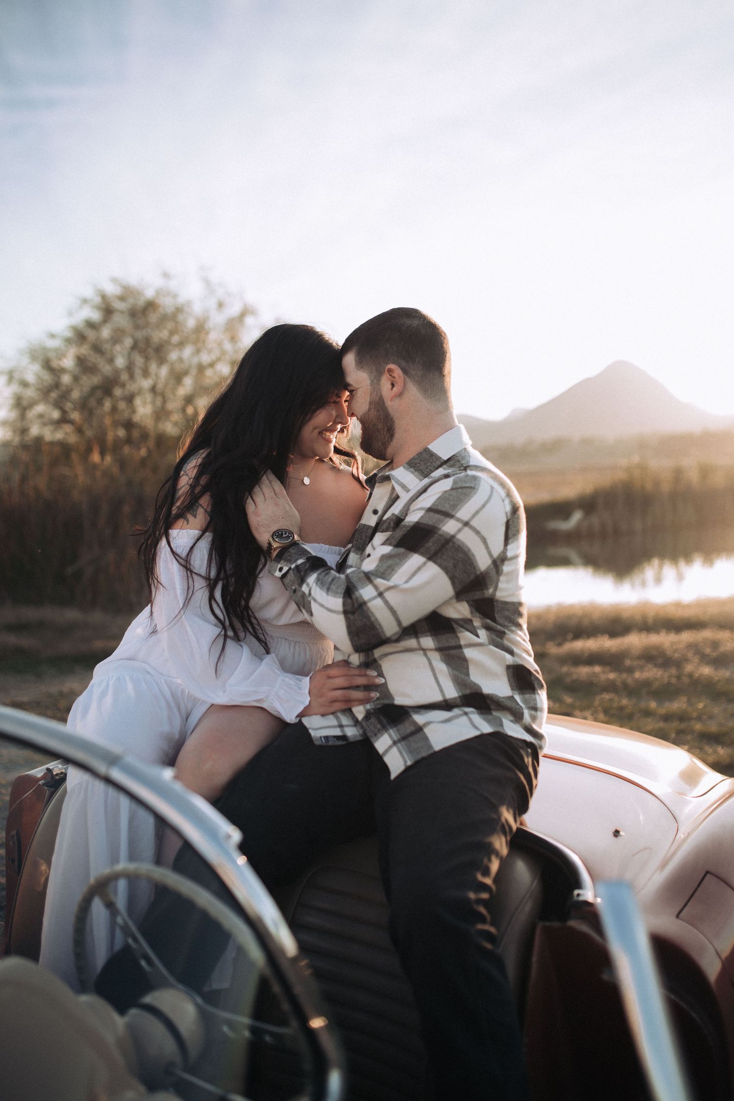 A romantic engagement session featuring a couple in a classic car in Northern California