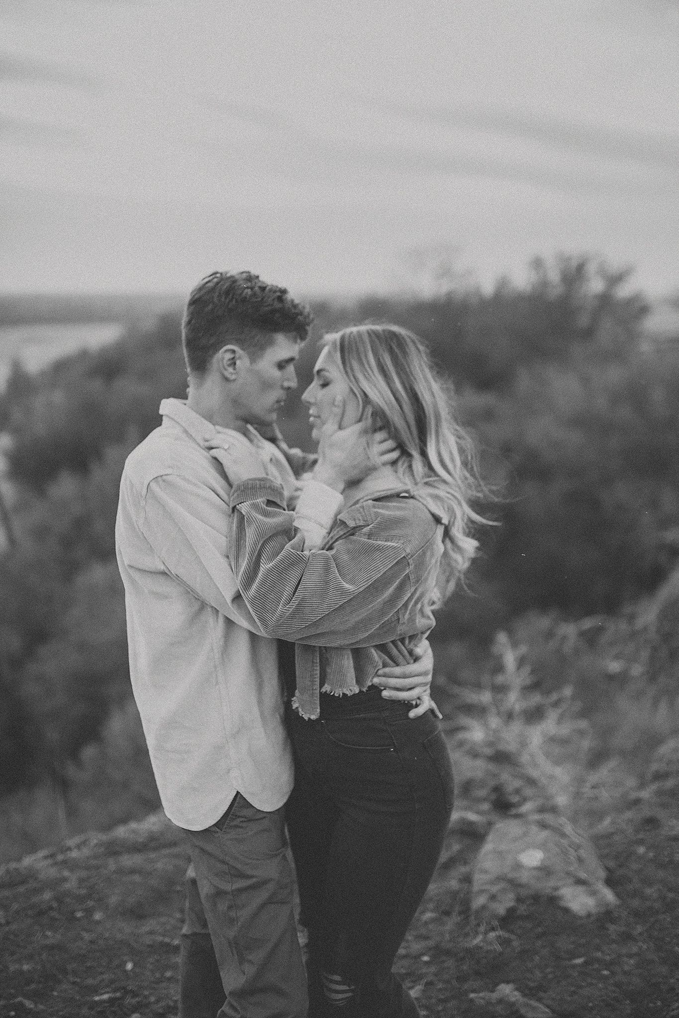 Couple embracing during an outdoor engagement session in North Idaho